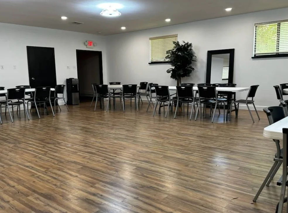 Inside the venue hall, set up with tables and chairs